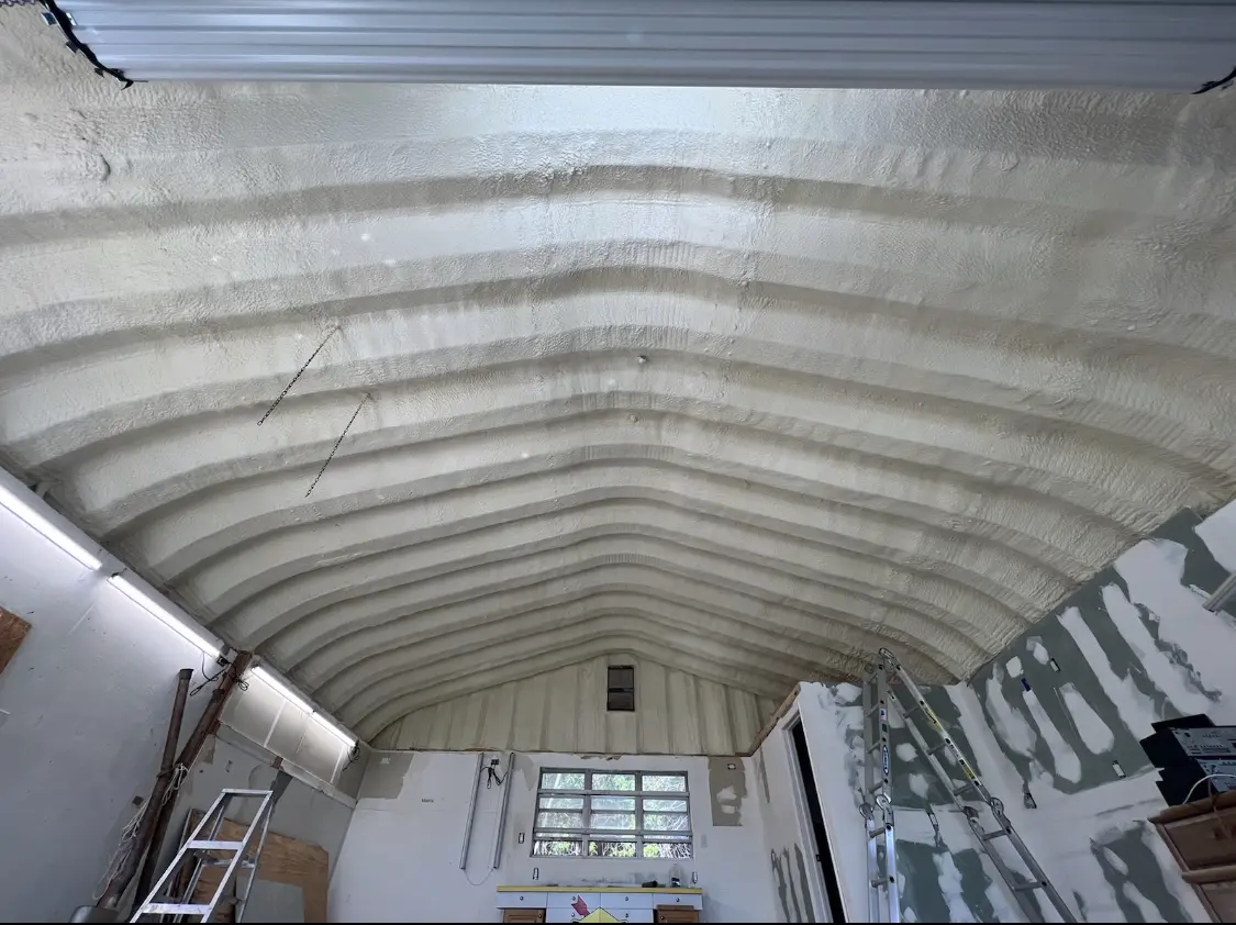 Spray polyurethane foam applied to the underside of a metal roof deck in Hollins